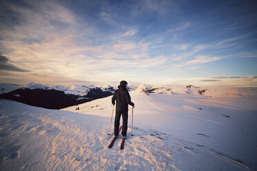 Rear view of skier standing on snowcapped mountain - CAVF17925