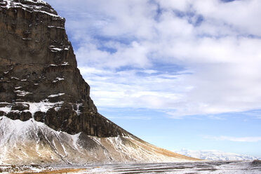 Majestic view of cliff during winter against cloudy sky - CAVF18003