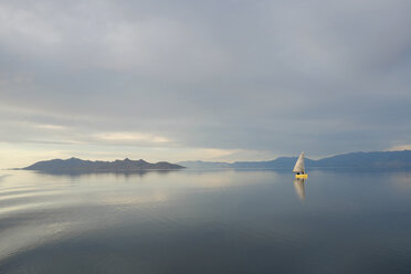 A small wooden boat moored in open water, off the Portuguese coast. stock  photo