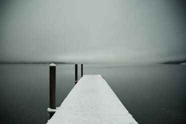 Snowy pier against by sea cloudy sky - CAVF18049