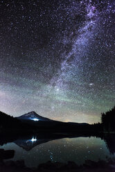 Idyllic view of mountain and lake against milky way at night - CAVF18207