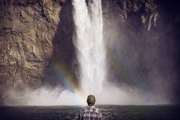 Rear view of boy standing against Snoqualmie Falls - CAVF18230