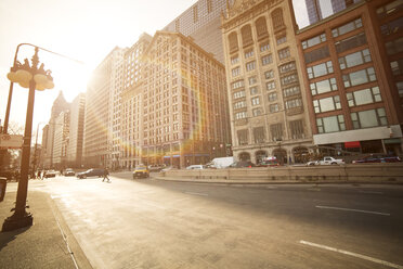 Modern buildings by city street on sunny day - CAVF18467