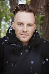 Portrait of man during snowfall - CAVF18592