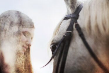 Young woman by horse against clear sky - CAVF18832