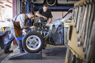 Mechanics repairing car at auto repair shop - CAVF19117