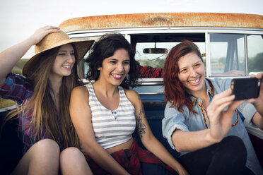 Friends taking selfie while traveling in pick-up truck - CAVF19158