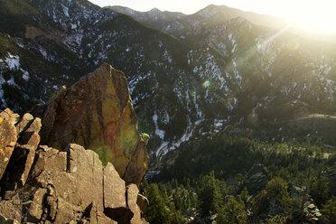 Man climbing rock mountain on sunny day - CAVF19242