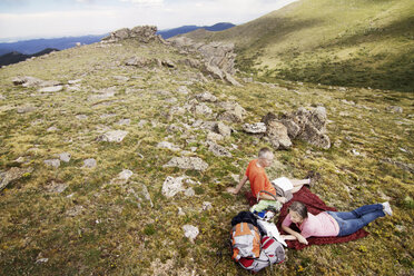 High angle view of couple relaxing on mountain - CAVF19312