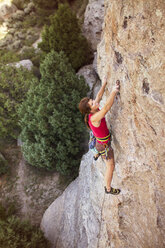 High angle view of female climber climbing mountain - CAVF19340