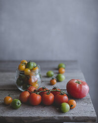 Close-up of tomatoes on wooden table - CAVF19501
