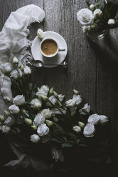 Overhead view of coffee with white roses on wooden table - CAVF19512