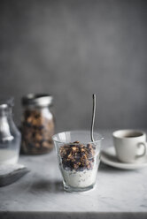 Close-up of granola and yogurt with coffee on table - CAVF19584