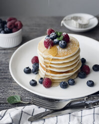 Pancakes and berries in plate on table - CAVF19647