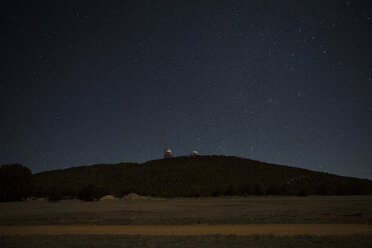 Scenic view of landscape against starry sky at night - CAVF19749