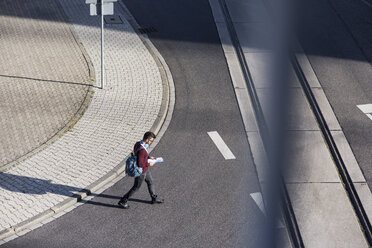 High angle view of man walking on road - CAVF20312