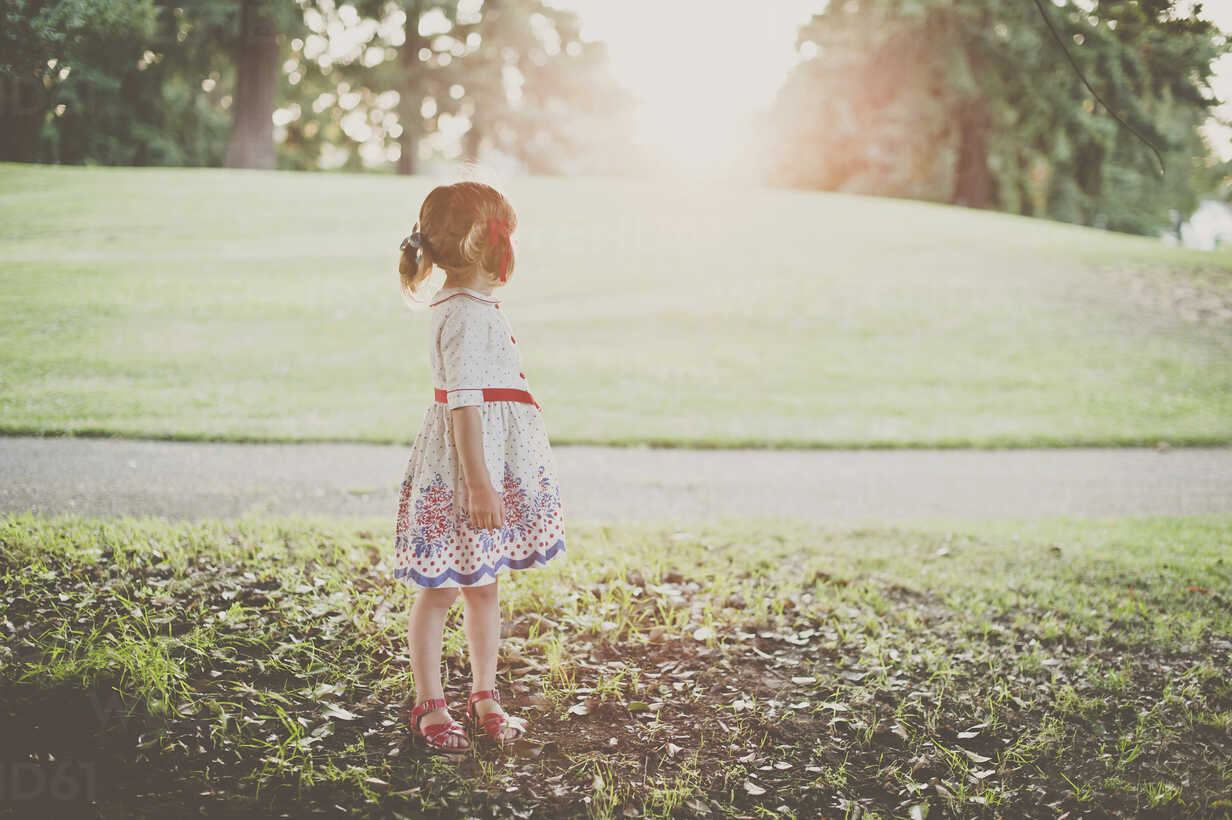 Side view of girl standing at park stock photo