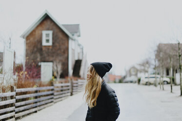 Girl standing on street during winter - CAVF20466
