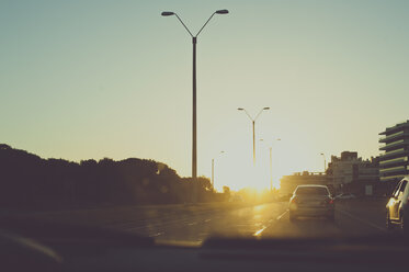 Cars on city street during sunset - CAVF20493