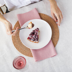 Overhead view of woman having slice of pie at table - CAVF20578