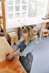 Overhead view of woman working in pottery workshop - CAVF20621