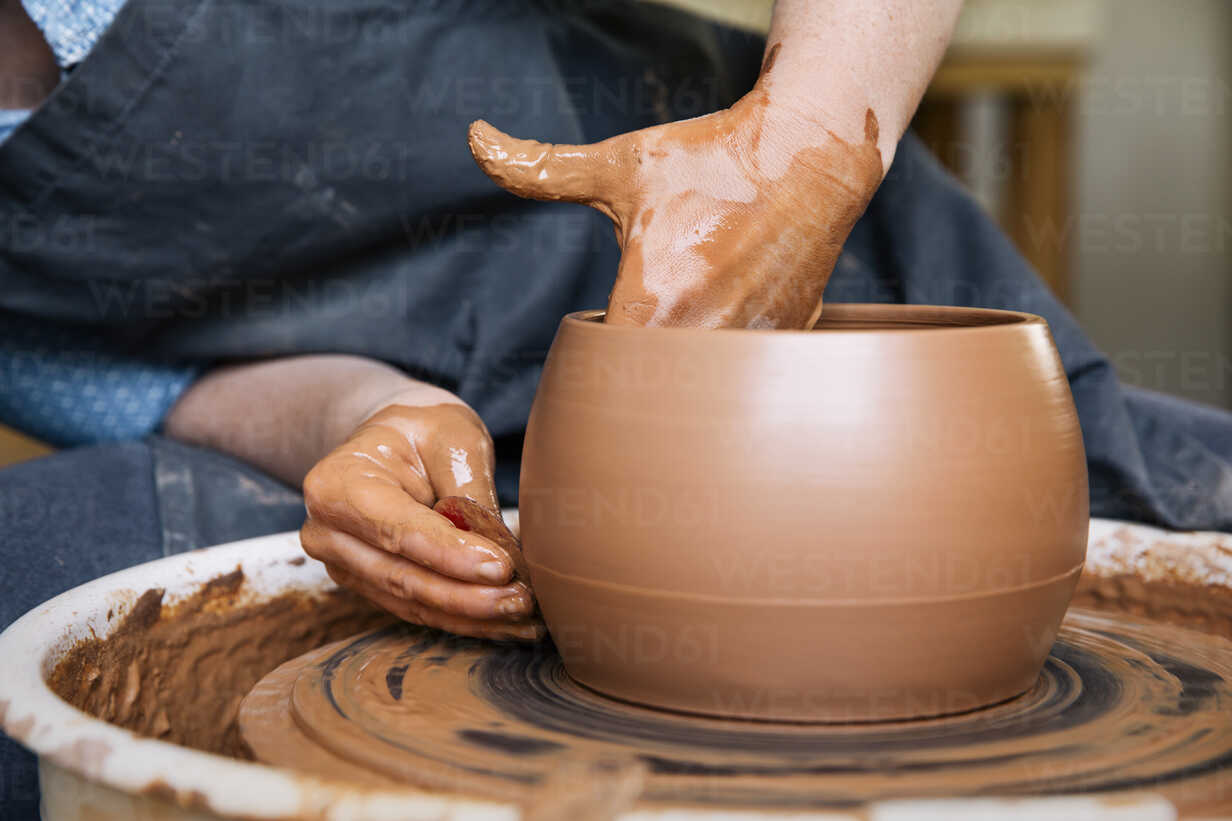 Molding clay on the wheel