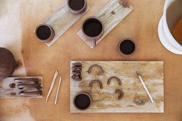 Overhead view of earthenware with equipment on table - CAVF20636