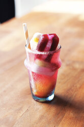 Close-up of flavored ice cubes in glass on table - CAVF20703