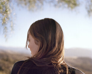 Rear view of woman against clear sky - CAVF20740