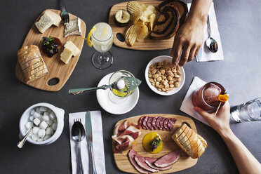 Overhead view of hands eating meal at table - CAVF20762