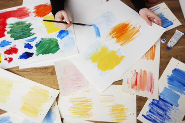 Cropped image of hands painting on paper - CAVF20874