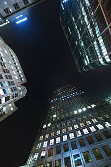 Low angle view of illuminated skyscrapers against clear sky at night - CAVF22048