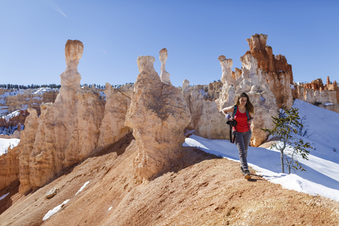 Female hiker hiking on mountain at Bryce Canyon National Park during sunny day stock photo