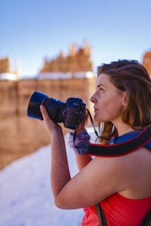 Hiker photographing while standing on mountain at Bryce Canyon National Park - CAVF22575