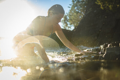 Low angle view of woman on shore during sunny day - CAVF22623