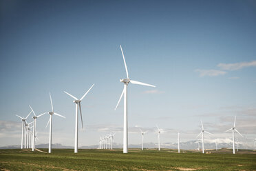 Wind turbines on field against blue sky - CAVF22639