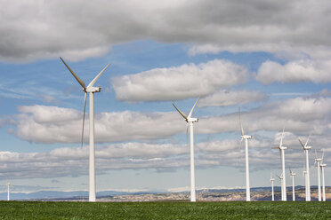 Wind turbines on field against cloudy sky - CAVF22656