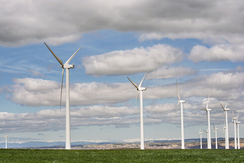 Wind turbines on field against cloudy sky - CAVF22656