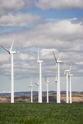 Wind turbines on field against sky - CAVF22657