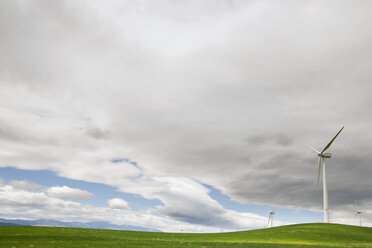 Wind turbines on field against cloudy sky - CAVF22662
