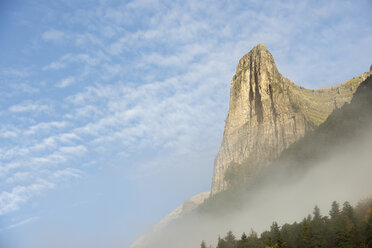 Low angle view of mountain against sky during foggy weather - CAVF22726