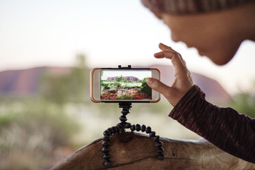 Cropped image of woman photographing mountains - CAVF22832