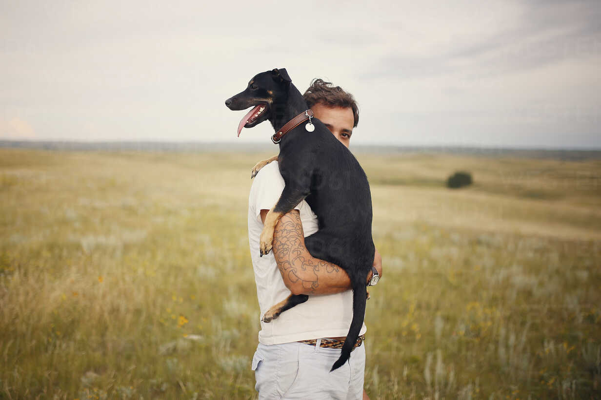 Dog being carried hi-res stock photography and images - Alamy