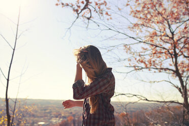 Side view of woman against sky during autumn - CAVF23039