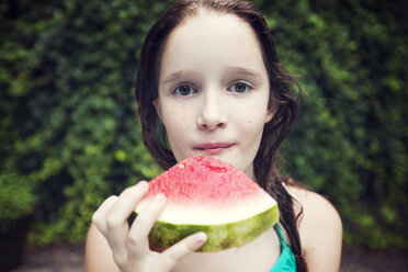 Close-up portrait of girl eating watermelon slice - CAVF23304