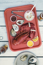 Overhead view of lobster and oysters served in tray on table - CAVF23366