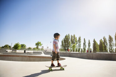 Side view of boy skateboarding on ramp - CAVF23428