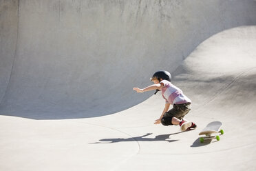 Boy falling on skateboard ramp - CAVF23430