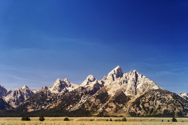 Scenic view of mountain against blue sky at Grand Teton National Park - CAVF23436