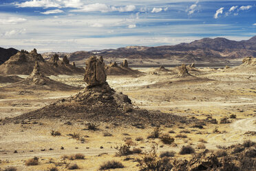Scenic view of arid landscape against cloudy sky - CAVF23443